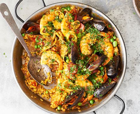 Paella with prawns and mussels served in a pan